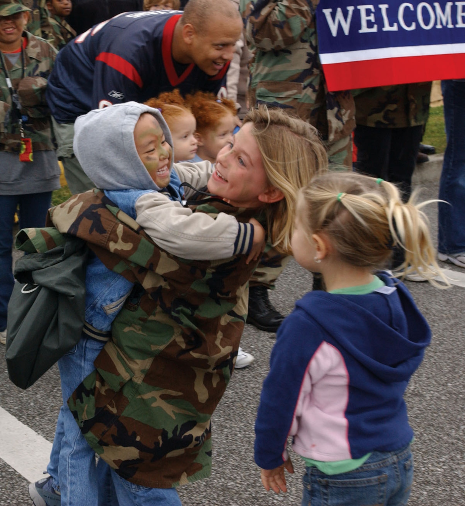 KADENA AIR BASE, Japan -- Mikaila Bantugan welcomes 6-year-old Jordan Deremer home from her simulated deployment to Iraq as part of an Operation Kids Understanding Deployment Operations event March 12.  More than 320 children participated in the event to learn more about how their military parents deploy.  Mikaila is the daughter of Tech. Sgt. Michael Bantugan of the 353rd Maintenance Squadron.  Jordan is the daughter of Staff Sgt. David Deremer of the 18th Communications Squadron.  (U.S. Air Force photo by Senior Airman Mercedes McAlister)