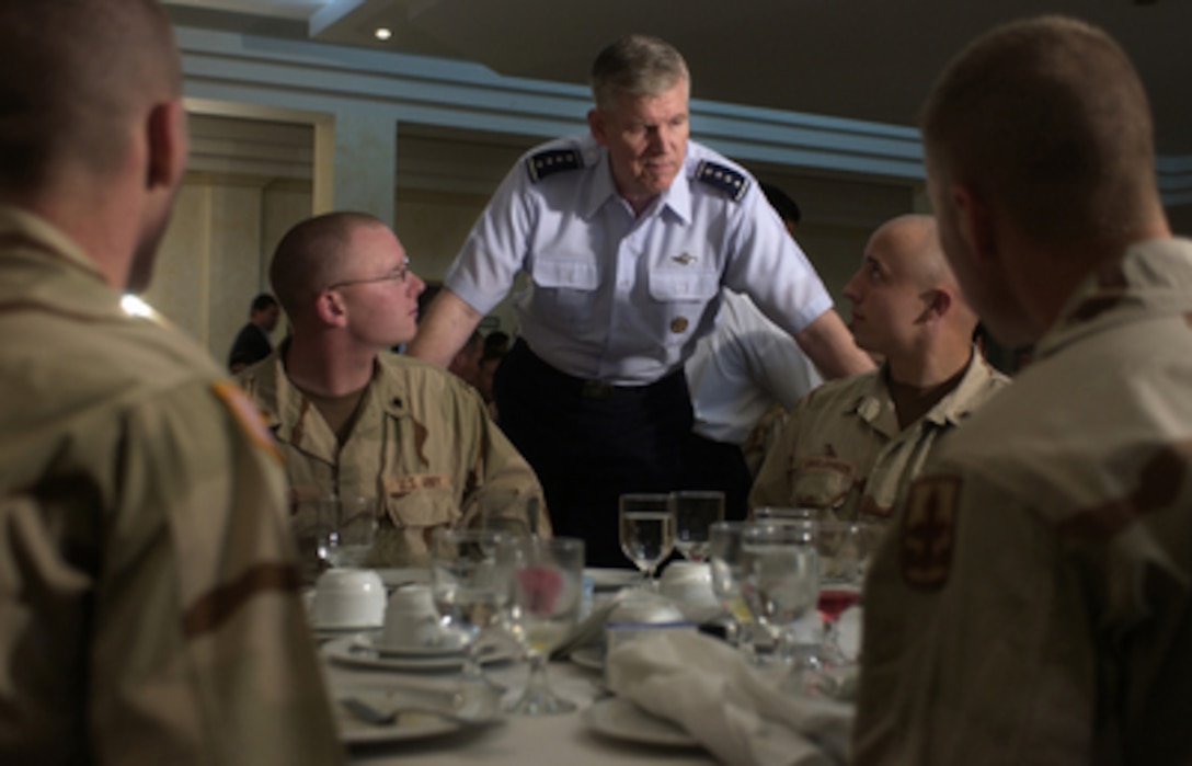 Chairman the Joint Chiefs of Staff Gen. Richard Myers, U.S. Air Force, talks with U.S. service members after having breakfast with them at the Eskan Village dining facility in Saudi Arabia on March 17, 2005. Myers is in the Southwest Asia region to meet with local commanders and deployed troops. 