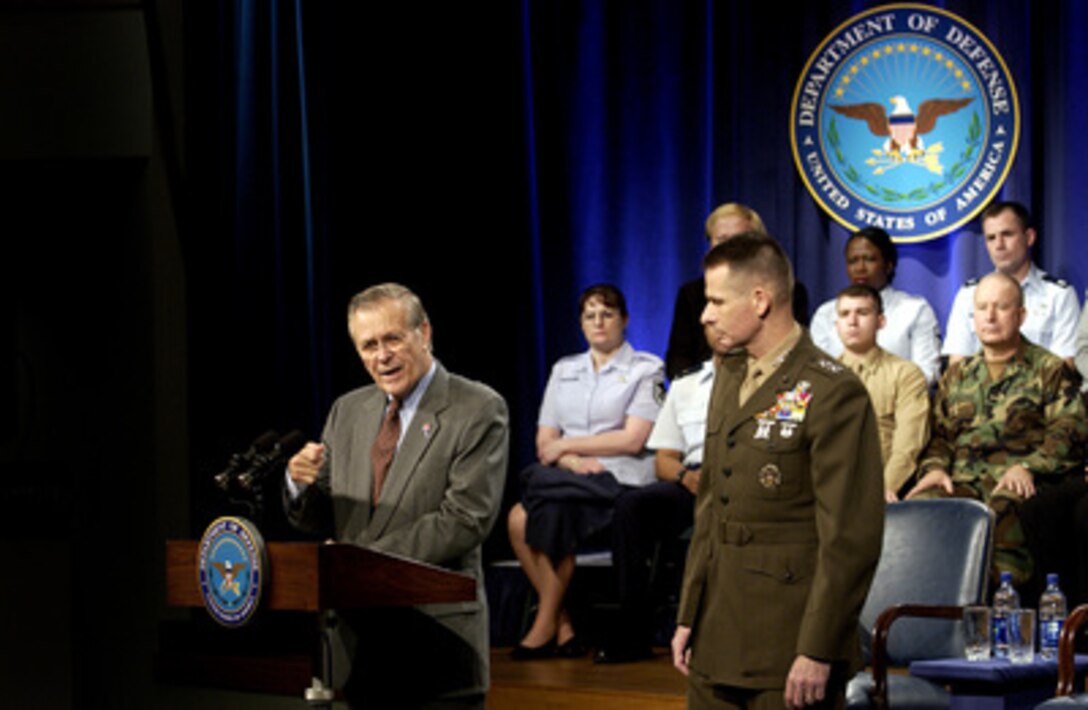 Secretary of Defense Donald H. Rumsfeld answers questions from members of the military and Department of Defense employees during a Pentagon town hall meeting in Arlington, Va., on March 18, 2005. Vice Chairman of the Joint Chiefs of Staff Gen. Peter Pace, U.S. Marine Corps, joined Rumsfeld at the meeting on the second anniversary of the beginning of Operation Iraqi Freedom. 