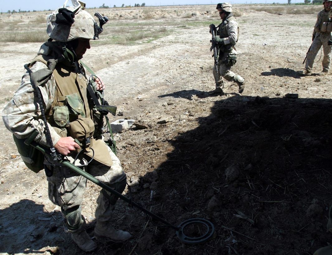 BAGHDAD, Iraq -- (Mar. 18, 2005) -  Cpl. Timothy McClintock, and engineer with Bravo Co. 1/1, part of the 15th Marine Expeditionary Unit (Special Operations Capable), scans a dirt mound for a weapons cache. The 15th MEU (SOC) is conducting security and stabilization operations in the Greater Baghdad area.