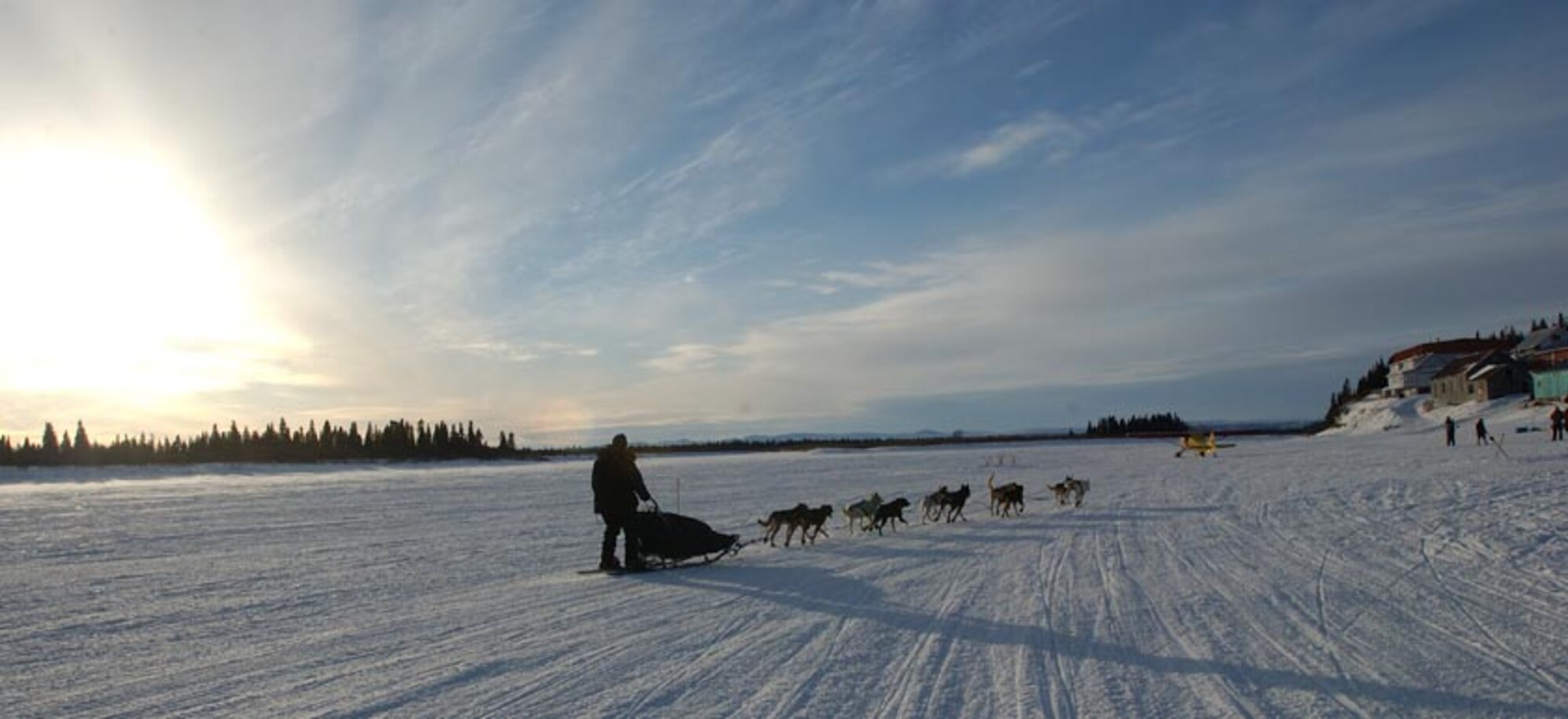 WHITE MOUNTAIN, Alaska -- Maj. (Dr.) Tom Knolmayer drives his dog team into a checkpoint here, 77 miles from the Iditarod finish line in Nome, Alaska.  Dr. Knolmayer spent 13 days, 22 hours, 13 minutes and 25 seconds on the trail, covering 1,161 miles.  He is chief of surgery at Elmendorf Air Force Base, Alaska.  (U.S. Air Force photo by Tech. Sgt. Keith Brown)