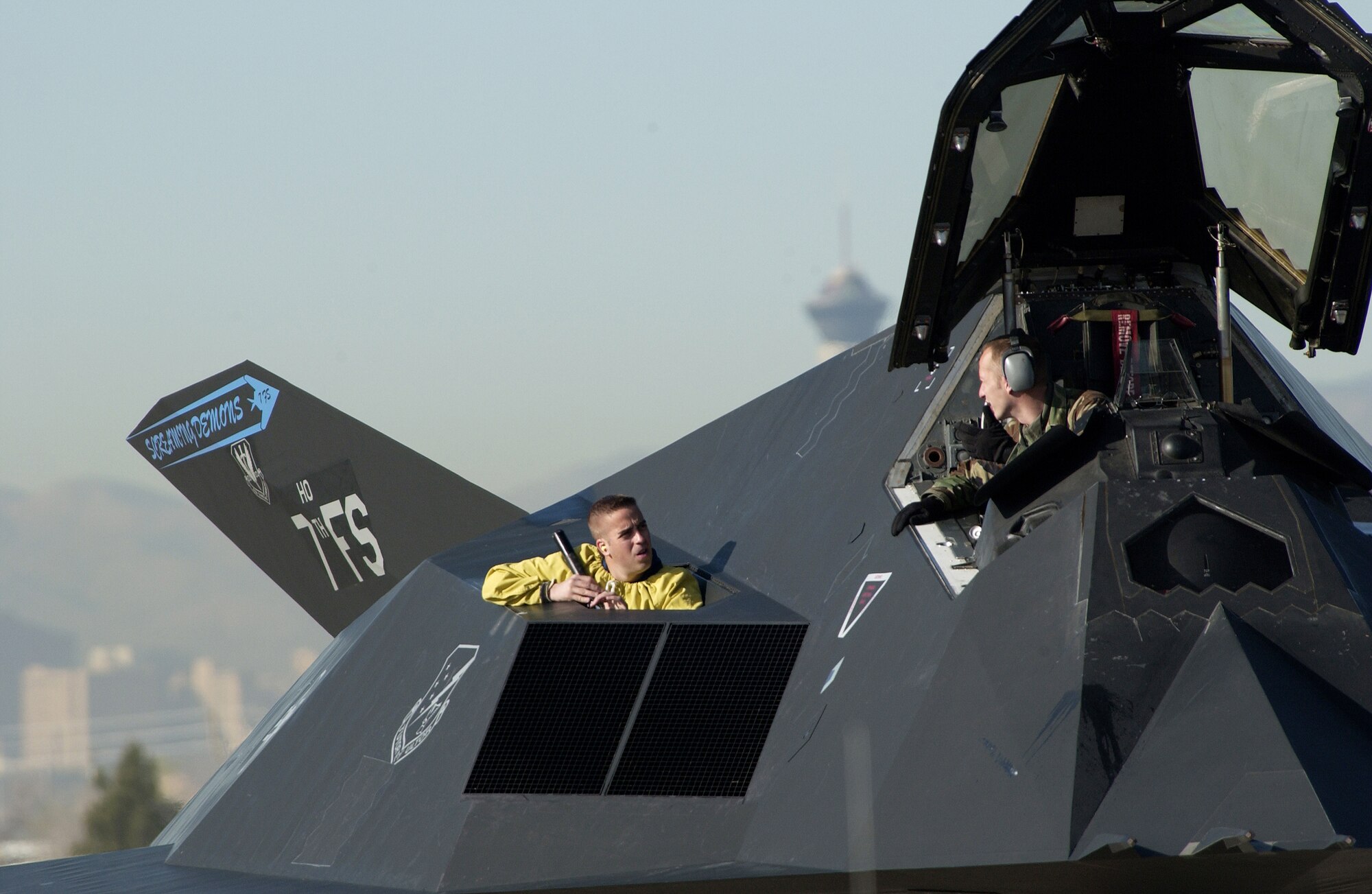 NELLIS AIR FORCE BASE, Nev. -- Staff Sgt. Robin Walker (left) and Staff Sgt. Greg Slavik prepare an F-117 Nighthawk stealth fighter to launch from here.  Aircraft, aircrews, maintainers and support Airmen from around the globe are here during March to participate in Red Flag, an Air Force exercise that tests warfightering skills in real-time combat situations.  This is the Department of Defense's first Joint Red Flag exercise, in which more than 10,000 servicemembers from all four military branches, along with troops of some coalition forces, will train in an effort to develop improved joint training and experimentation capabilities.  Sergeants Walker and Slavik are crew chiefs assigned to the 49th Aircraft Maintenance Squadron at Holloman Air Force Base, N.M.  (U.S. Air Force photo by Tech. Sgt. Kevin J. Gruenwald) 