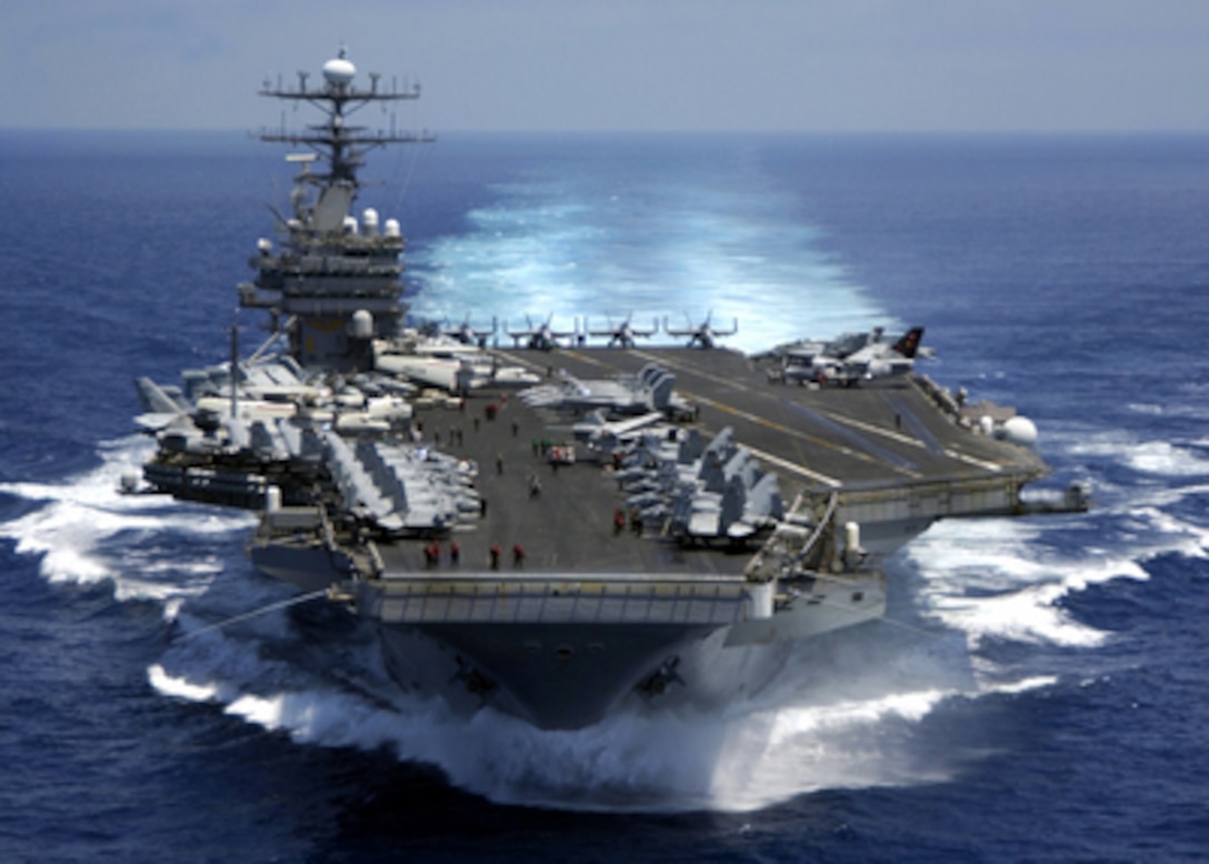 The nuclear powered aircraft carrier USS Carl Vinson (CVN 70) plows through the Indian Ocean as aircraft on its flight deck are prepared for flight operations on March 15, 2005. The Carl Vinson Strike Group is en route to the Persian Gulf to support for Operation Iraqi Freedom. 