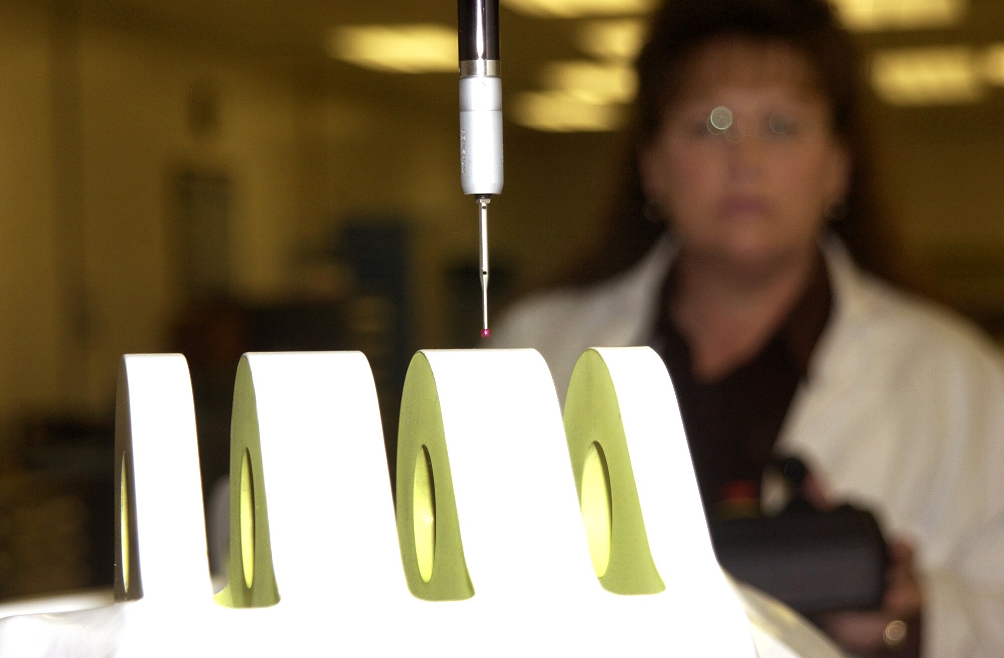 HILL AIR FORCE BASE, Utah -- Using the red-tipped trigger touch of the coordinate measurement machine, Connie Adams takes a three-dimensional measurement.  She is an engineering technician in the quality verification center here.  (Courtesy photo)