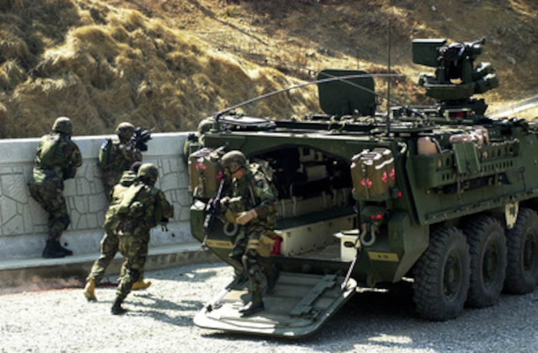 U.S. Army soldiers deploy out of a Stryker Infantry Carrier Vehicle in order to provide suppressive fire on the enemy while participating in a simulated convoy attack during exercises Reception, Staging, Onward movement, and Integration/Foal Eagle in the Republic of Korea, on March 20, 2005. The annual, multi-phase exercise is tailored to train, test, and demonstrate U.S. and Republic of Korea force projection and deployment capabilities. 
