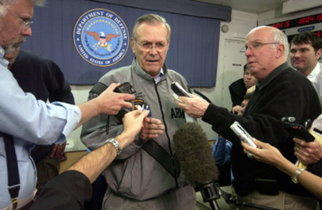 Secretary of Defense Donald H. Rumsfeld (center) talks with members of the press onboard an aircraft en route to Buenos Aires, Argentina, on March 21, 2005. Rumsfeld is traveling to South and Central America to meet with key government officials and his defense counterparts to strengthen bilateral ties. 