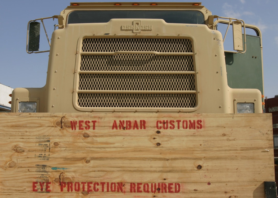 HADITHAH, Al Anbar, Iraq-  This simple board lets Marines with 3/25 know that this where they can get their vehicles  upgraded and customized to military perfection.  (Official USMC Photo by Corporal Ken Melton)