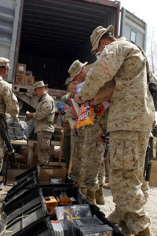AL ASAD, Iraq (March 25, 2005) - Marines and other U.S. service members stationed in Hit, Iraq, line up to purchase cigarettes, candy, snack foods and various other items from the mobile exchange March 23. Marines from Headquarters and Service Battalion and Combat Logistics Battalion - 2, 2d Marine Logistics brigade (Forward), conducted Warfighter Express Services Team operation, offering exchange, postal and disbursing services to about 200 service members during this trip. (Photo by: Cpl. John E. Lawson Jr.)