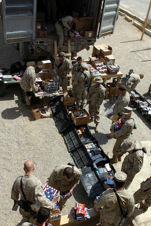 AL ASAD, Iraq (March 25, 2005) - Marines and other U.S. service members stationed in Hit, Iraq, line up to purchase cigarettes, candy, snack foods and various other items from the mobile exchange March 23. Marines from Headquarters and Service Battalion and Combat Logistics Battalion - 2, 2d Marine Logistics brigade (Forward), conducted Warfighter Express Services Team operation, offering exchange, postal and disbursing services to about 200 service members during this trip. (Photo by: Cpl. John E. Lawson Jr.)