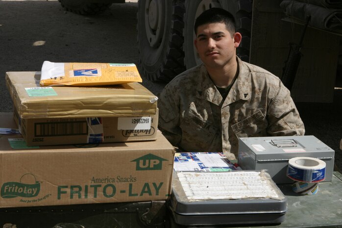 AL ASAD, Iraq (March 25, 2005) - Lance Cpl. Mario Acosta, a postal clerk with Headquarters and Service Battalion, 2d Marine Logistics brigade (Forward), waits for additional customers during a Warfighter Express Services Team operation in Hit, Iraq, March 23. The San Bernardino, Calif., native participated in the WES Team Operation, offering postal, disbursing and exchange services to Marines and other U.S. service members stationed in the remote regions of Iraq where such services are not normally available. (Photo by: Cpl. John E. Lawson Jr.)