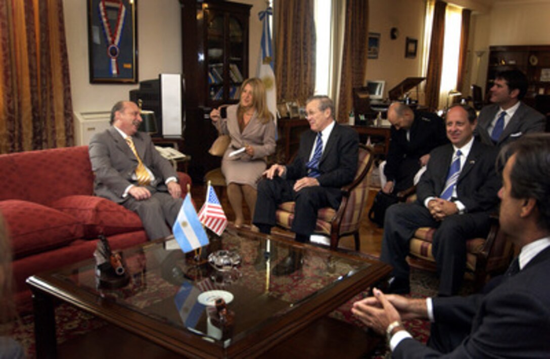 Argentinean Minister of Defense Jose Pampuro (left) and Secretary of Defense Donald H. Rumsfeld (3rd from left) share a lighter moment as they begin a bilateral meeting at the Ministry of Defense in Buenos Aries, Argentina, on March 22, 2005. Rumsfeld is traveling to South and Central America to meet with key government officials and his defense counterparts to strengthen bilateral ties. 
