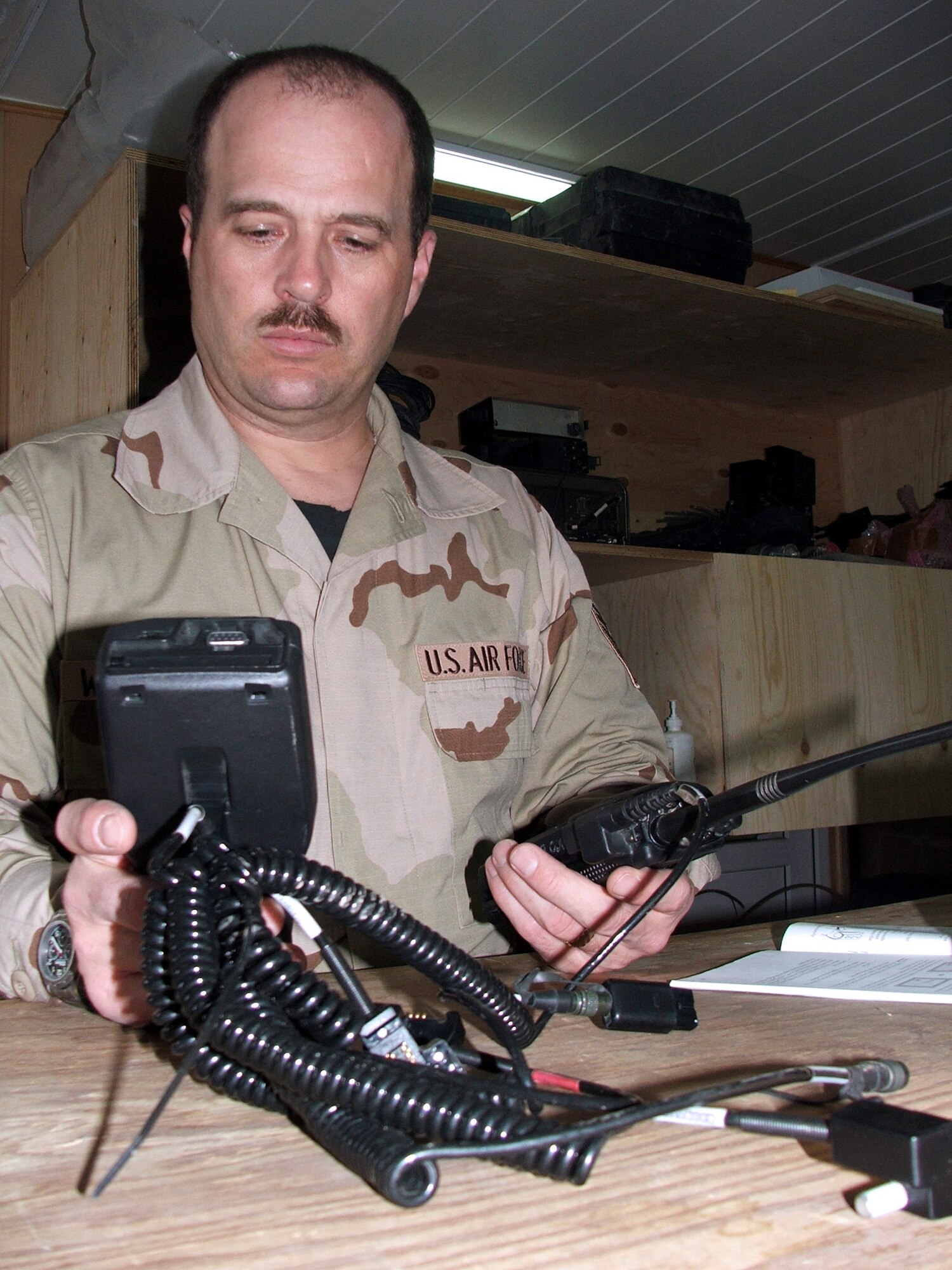 KARSHI-KHANABAD AIR BASE, Uzbekistan -- Tech. Sgt. Kerry Westerfield tests a radio here March 15.  He is the noncommissioned officer in charge of personal wireless communications for the 416th Expeditionary Mission Support Squadron communications flight and is deployed from Travis AFB, Calif.  (U.S. Air Force photo by Tech. Sgt. Scott T. Sturkol)
