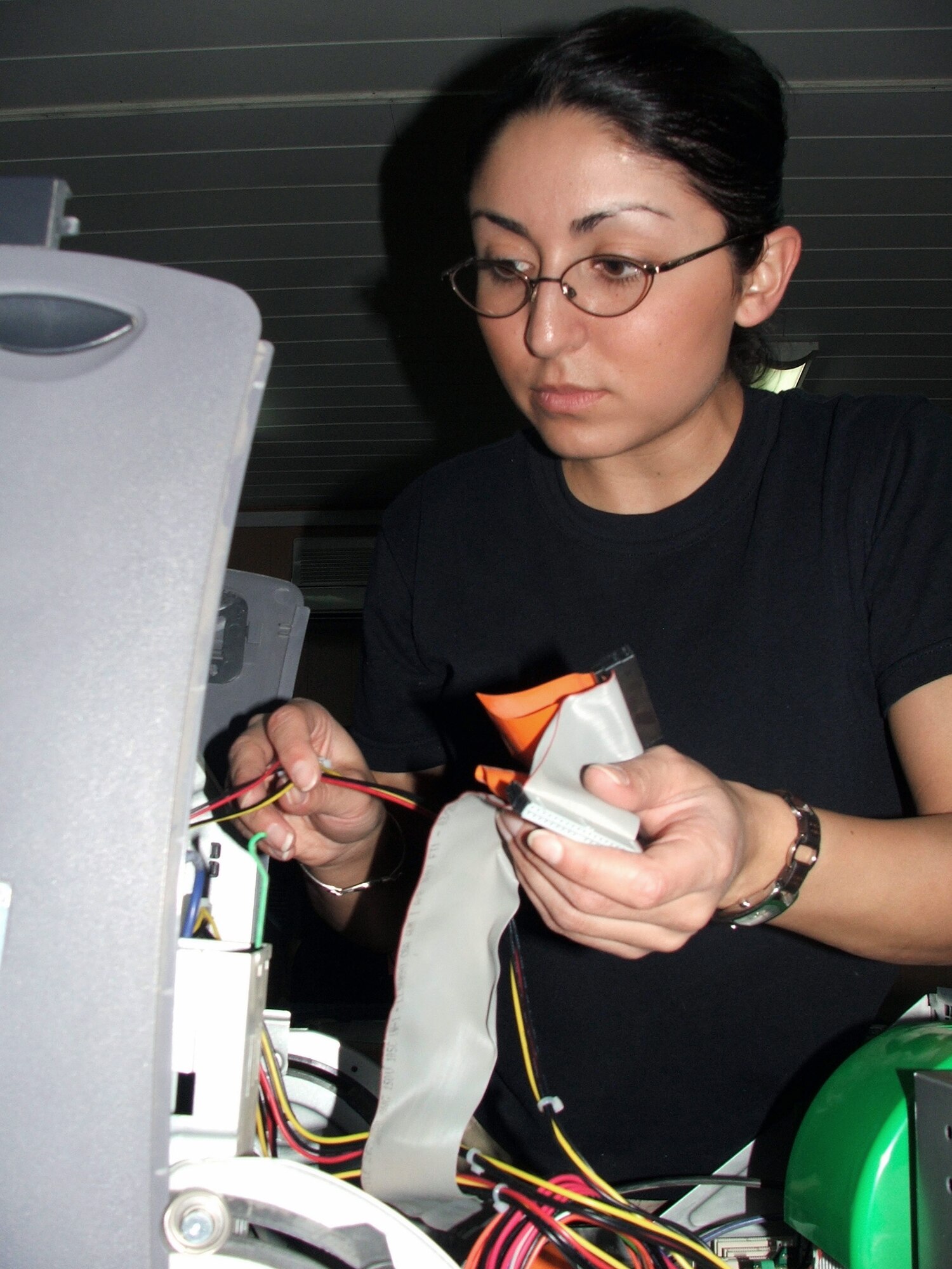 KARSHI-KHANABAD AIR BASE, Uzbekistan -- Senior Airman Rosie Alvarado repairs a computer here March 15.  She is a communications-computer systems operations journeyman assigned to the 416th Expeditionary Mission Support Squadron communications flight and is deployed from Vandenberg Air Force Base, Calif.  (U.S. Air Force photo by Tech. Sgt. Scott T. Sturkol)