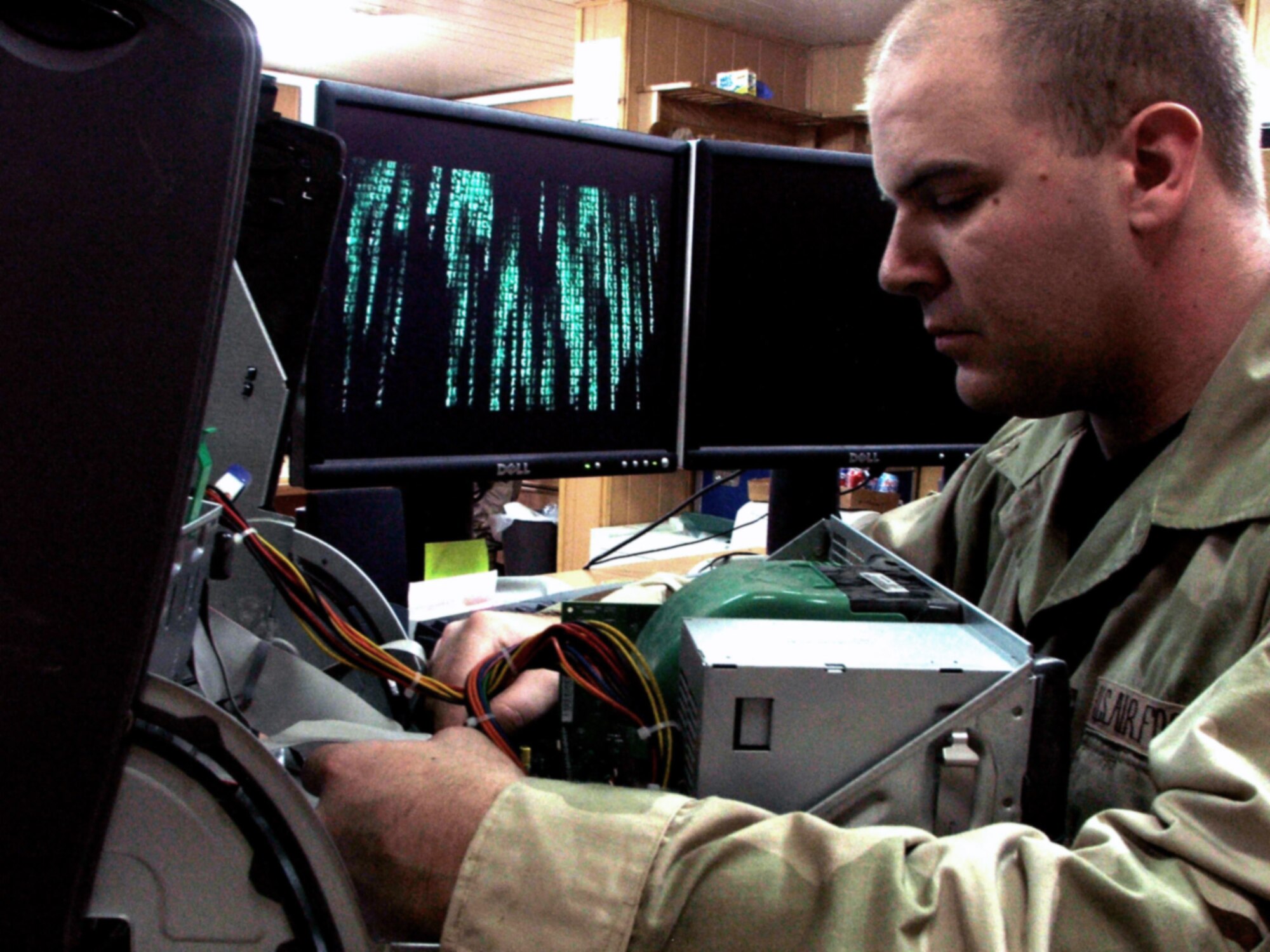 KARSHI-KHANABAD AIR BASE, Uzbekistan -- Staff Sgt. Brandon Miranda repairs a computer here March 15.  He is a communications-computer systems operations journeyman assigned to the 416th Expeditionary Mission Support Squadron communications flight and is deployed from Grand Forks Air Force Base, N.D.  (U.S. Air Force photo by Tech. Sgt. Scott T. Sturkol)