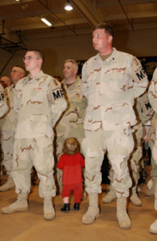 A little girl looks for her father in a military formation during a homecoming ceremony for the New Hampshire National Guard's 2nd Battalion, 197th Field Artillery Brigade, at Plymouth High School, N.H., on March 4, 2005. The soldiers returned home from a 14-month deployment to Iraq in support of Operation Iraqi Freedom. 