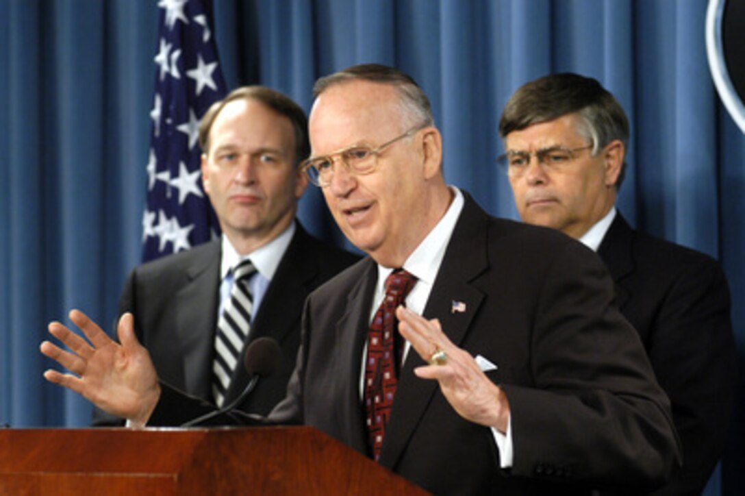 Assistant Secretary of Defense for Reserve Affairs Thomas Hall (center) responds to a reporter's question concerning the new health care plan being made available to eligible National Guard and Reserve members during a Pentagon press briefing on March 24, 2005. The TRICARE Reserve Select program is designed to cover the individual service member as well as his or her dependents and will terminate at the end of the subscriber's service agreement. Joining Hall to explain the plan are Assistant Secretary of Defense for Health Affairs Dr. William Winkenwerder Jr. (left) and Deputy Under Secretary of Defense for Personnel and Readiness Charles Abell (right). 