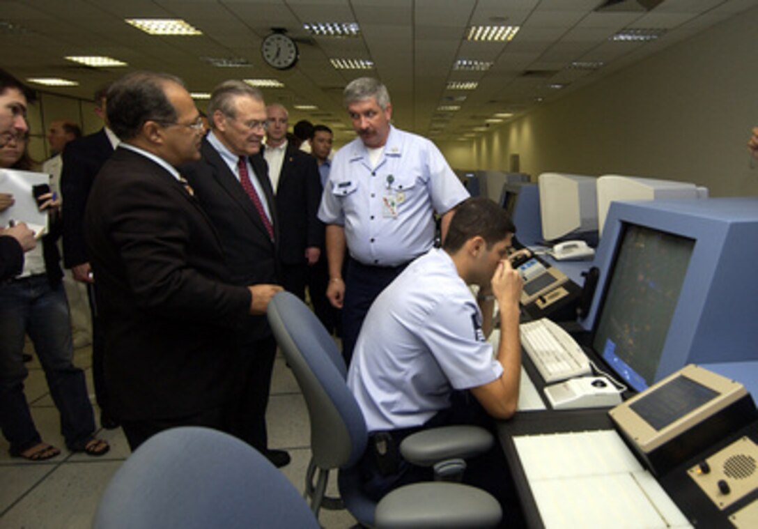 Brazilian Maj. Gen. Pinhiero (center) conducts a tour of the Amazon Surveillance System or Sistema Vigilancia Amazonica complex for Secretary of Defense Donald H. Rumsfeld (2nd from left) in Manaus, Brazil, on March 23, 2005. Sistema Vigilancia Amazonica is a ground and air surveillance system, and provides Brazil the capability to detect forest fires, illegal mining, and deforestation in the Amazon region. In addition to such environmental benefits, the system also serves various military purposes, including the ability monitor air space and detect illegal drug trafficking flights. Rumsfeld is traveling to South and Central America to meet with key government officials and his defense counterparts to strengthen bilateral ties. 