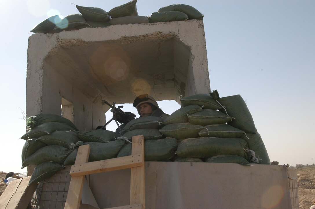 BAGHDAD, Iraq -- (March 24, 2005) -  Lance Cpl. Ian Diaz, 21, a motor transport mechanic with Battalion Landing Team 1/1 mans a guard tower at a vehicle checkpoint here. The 15th Marine Expeditionary Unit (Special Operations Capable) is currently conducting security and stability operations here in the greater Baghdad area. (Official USMC Photo by Gunnery Sgt. Robert Knoll)
