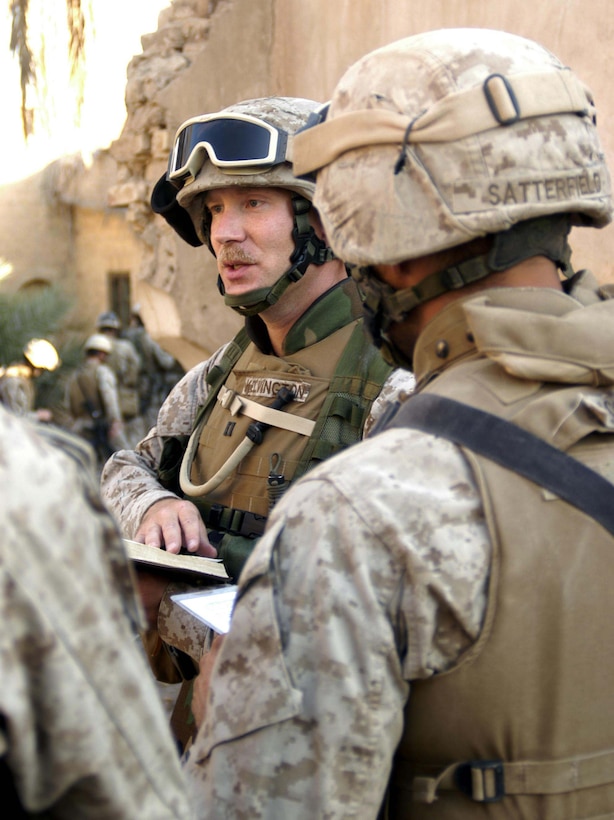 BAGHDAD, Iraq -- (Mar. 27, 2005) - Surrounded by Marines, Navy Lt. Doran Kelvington, 40, Protestant chaplain for Battalion Landing Team 1/1 and native of Bloomington, Minn., conducts an Easter service at Bravo Co.'s patrol base. The 15th Marine Expeditionary Unit (Special Operations Capable) is currently conducting security and stability operations here in the greater Baghdad area. (Official USMC Photo by Gunnery Sgt. Robert Knoll)