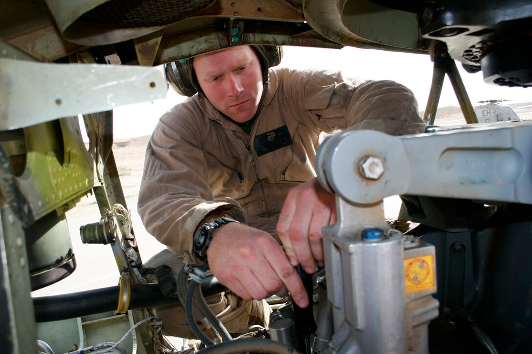 AL ASAD, Iraq -- Corporal Jedediah J. Larabee, an airframes and hydraulics mechanic assigned to Marine Medium Helicopter Squadron 264, bleeds air out of the rotor brake in a CH-46E Sea Knight on March 28.  Bleeding the air prevents hydraulic malfunctions on the aircraft.