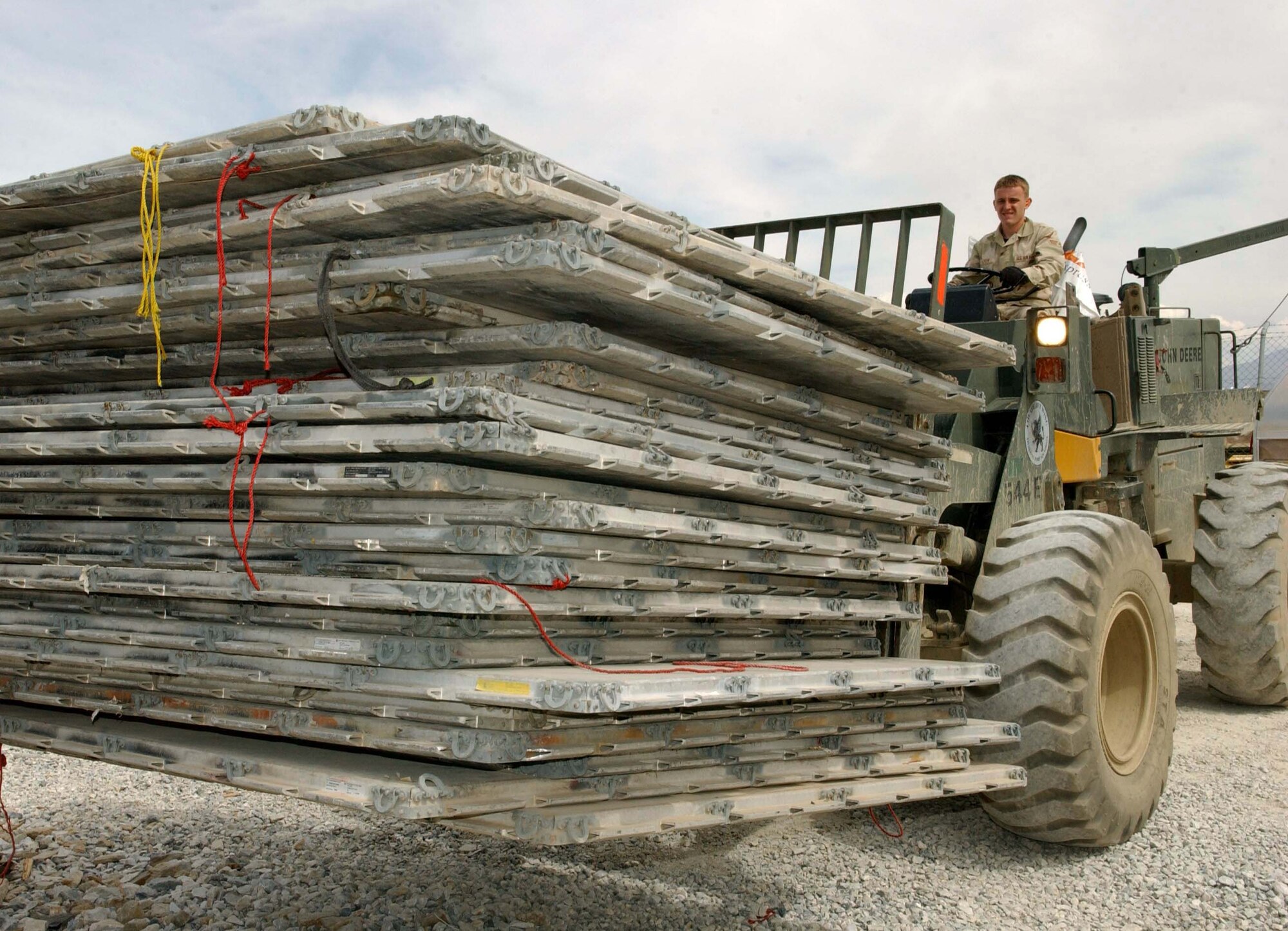 BAGRAM AIR BASE, Afghanistan -- Senior Airman Wesley Calhoun moves 25 pallets to the logistics storage.  Airman Calhoun is a squadron aircraft services team member.  Airmen of the 455th Expeditionary Logistics Readiness Squadron located 1,030 pallets and 3,550 top and side nets worth $1.7 million.