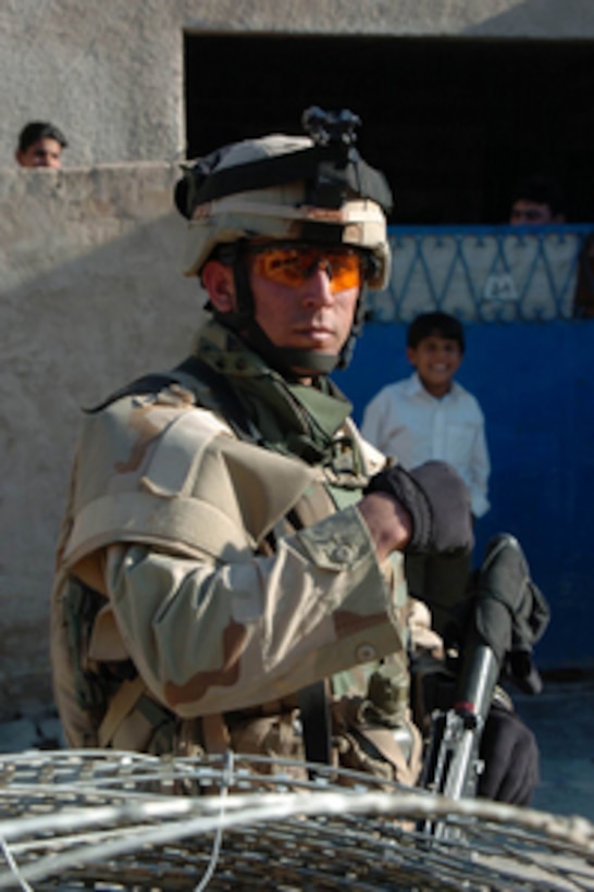 A U.S. Army soldier with Alpha Battery, 1st Battalion, 9th Field Artillery, 2nd Brigade, 3rd Infantry Division, stands guard during a routine patrol in Baghdad, Iraq, on March 19, 2005. 