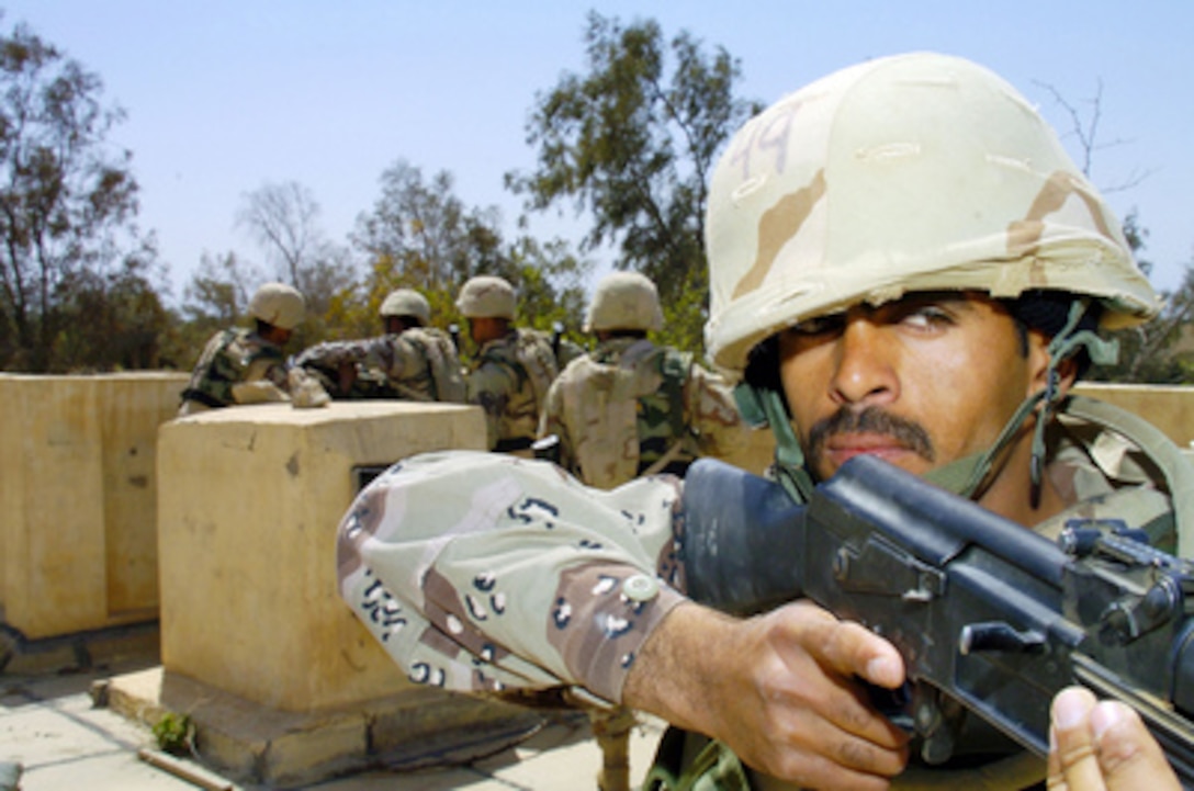 Iraqi graduates from the Center South Academy demonstrate the skills they learned in the Academy during a simulated assault demonstration at Camp Delta, in Al Kut, Iraq, on March 28, 2005. 