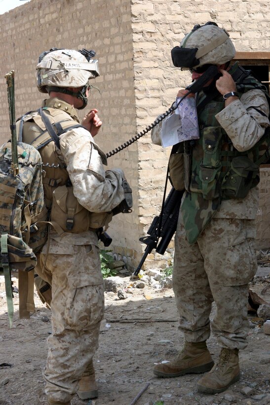 BAGHDAD, Iraq -- (March 30, 2005) - Captain Farrell, 30, commanding officer of A Co., Battalion Landing Team 1/1, and a native of Frederick Co. Md., uses a field radio along with Lance Cpl. Robert D. Hamil, 19, an infantry man from Spokane, Wash., during a patrol here. BLT 1/1, attached to the 15th Marine Expeditionary Unit (Special Operations Capable), is currently conducting security and stabilization operations in the Greater Baghdad area. (Official USMC photo by Lance Cpl. Thomas J. Grove)