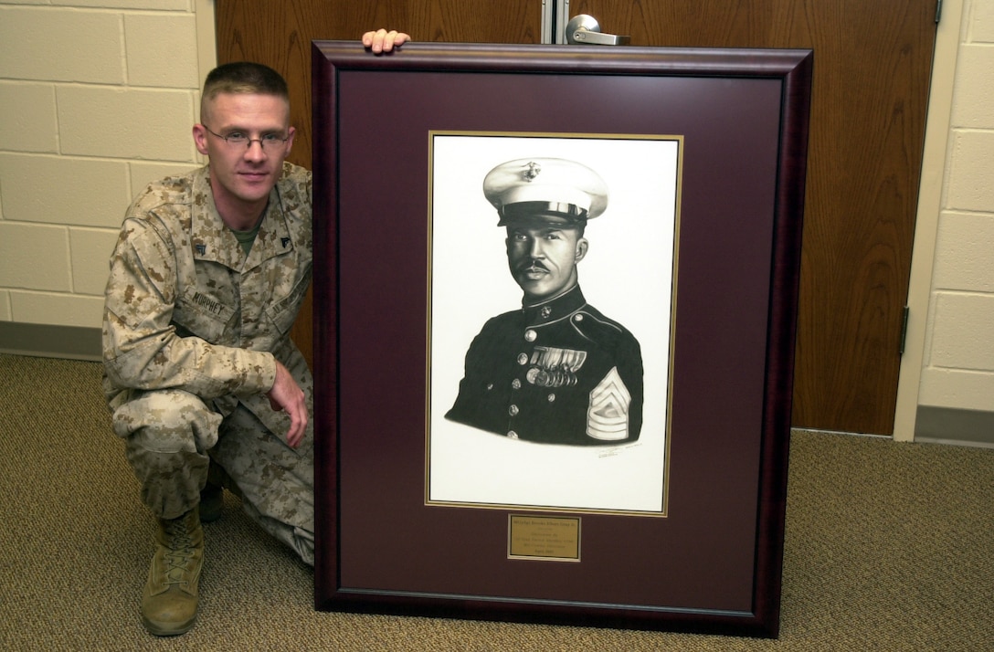 MARINE CORPS BASE CAMP LEJEUNE, N.C. - Corporal Sean Murphy, a combat illustrator with Combat Camera-Instructional Media, shows off his award-winning illustration which will be hung in the new Master Gunnery Sgt. Brooks Elbert Gray Jr. Consolidated Academic Instruction Facility.  Murphy won a Department of Defense award for his illustration, his third DoD award in two years. "I did the illustration for the building, because it's going to be named after him," said Murphy. "He was one of the founding members of the Montford Point Association." (Official Marine Corps photo by Lance Cpl. Shane Suzuki)