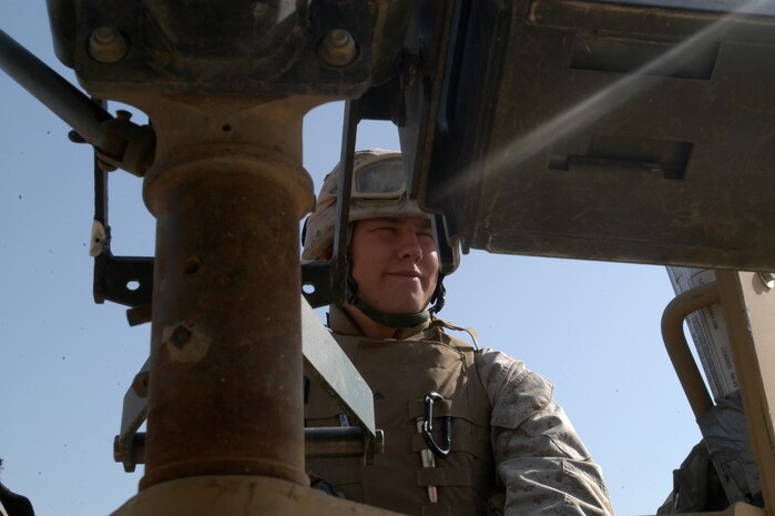 CAMP TAQADDUM, Iraq -- Lance Cpl. Jonathon "Boomhower" Burks, a 20-year-old military policeman with Alpha team, 3rd platoon, Bravo Company, 2d Military Police Battalion, Combat Logistics Regiment 25, 2d Force Service Support Group (Forward), takes time to joke around with other MPs before going on a security patrol.  Burks, who hails from Cullman, Ala., was nicknamed Boomhower after a TV show cartoon character because of his tendency to become incomprehensible when he gets excited.
