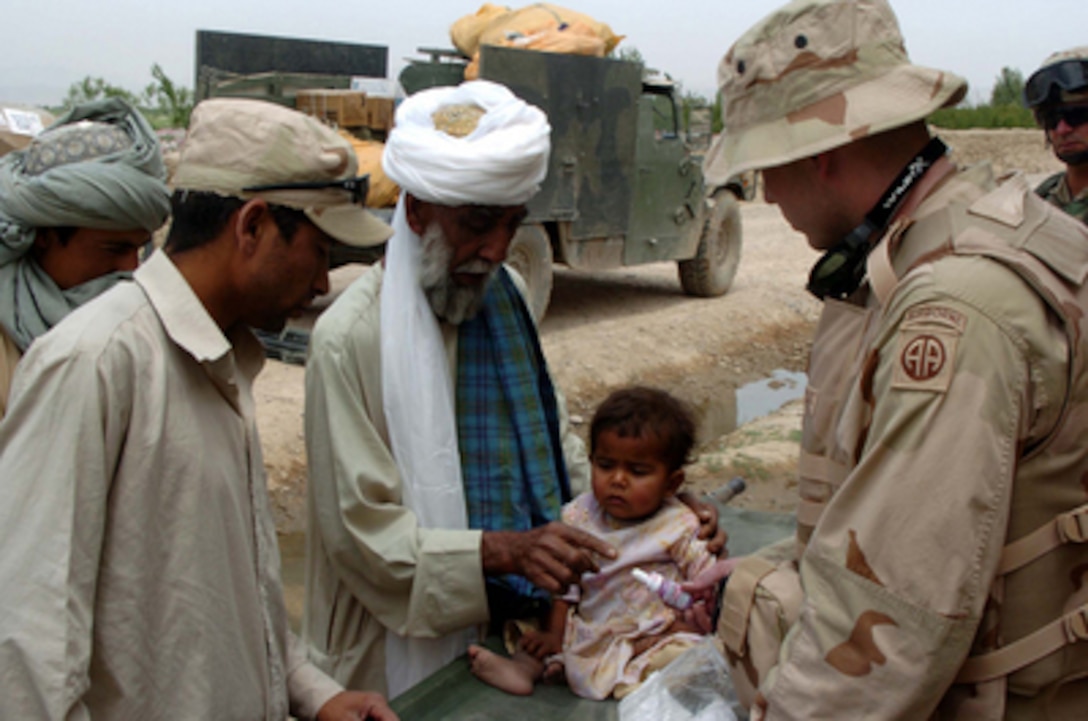 U.S. Army 2nd Lt. Scott Donoughe administers medical aid to a child in the Kandahar Province of Afghanistan during a coalition medical exchange, on April 28, 2005. Donoughe is a physician's assistant from the 3rd Battalion, 319th Headquarters Service Battery, 82ndAirborne Division, Fort Bragg, N.C. 