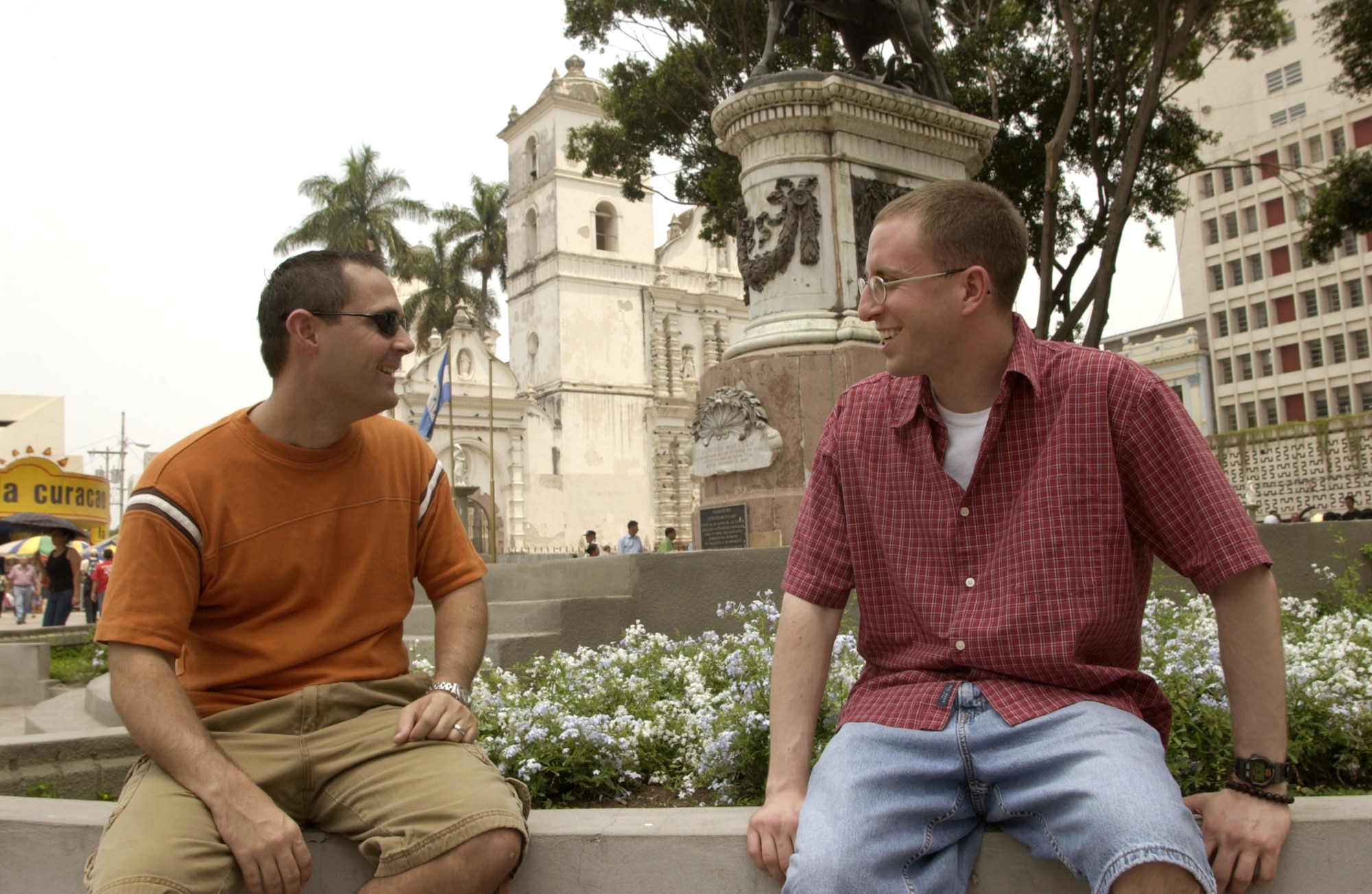 TEGUCIGALPA, Honduras -- Capts. Dan Beard and Cliff Bayne (left to right) take a breather at a monument in the capital city's Plaza Morazan. The two captains are logistics officers with Joint Task Force-Bravo at Soto Cano Air Base, Honduras. When they get a chance, both said they like to explore the country, which gives them a break from life at the austere base. (U.S. Air Force photo by Master Sgt. Lono Kollars)
