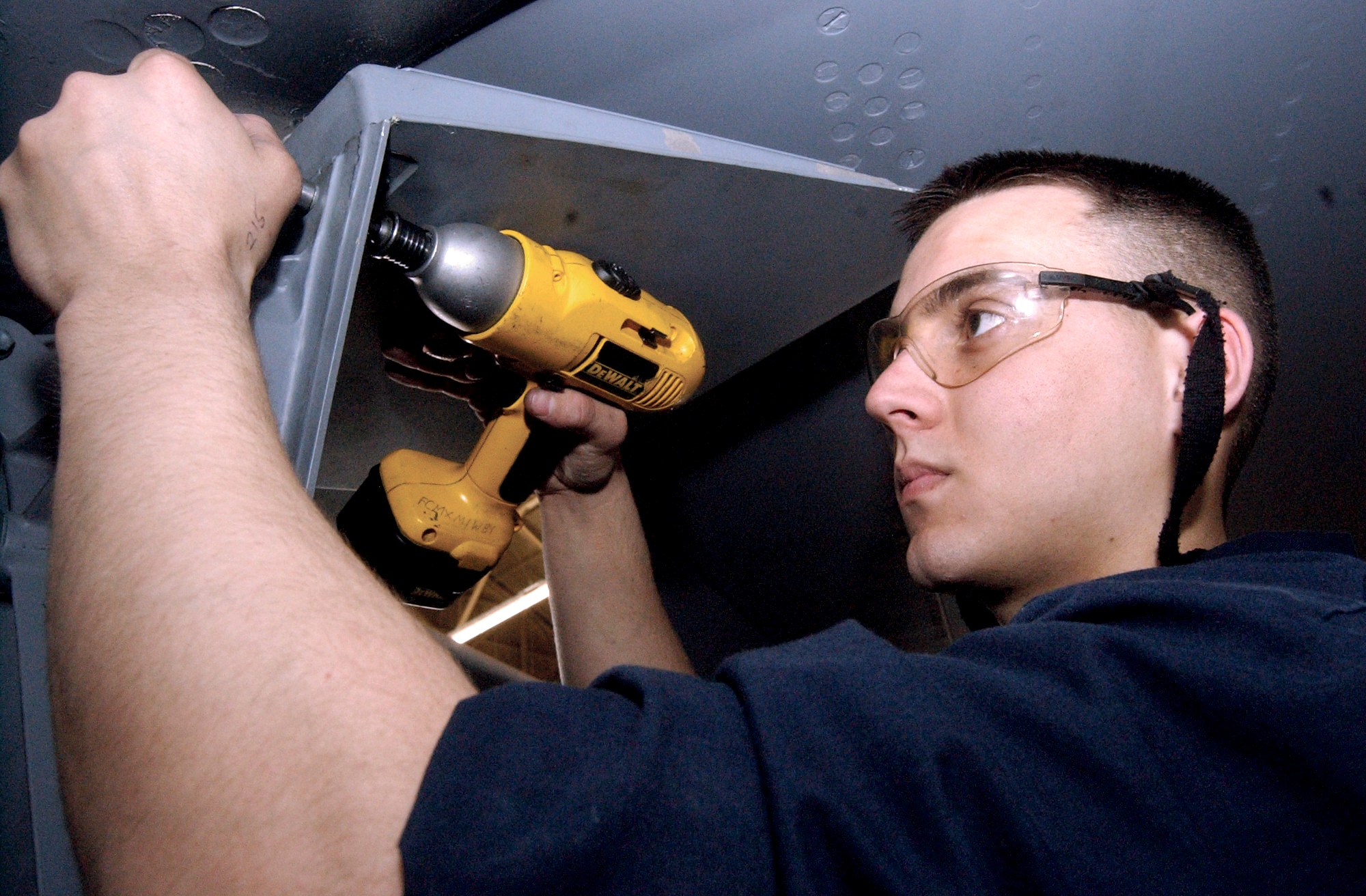 FAIRCHILD AIR FORCE BASE, Wash. -- Senior Airman Jack Ziegert bolts panels onto a KC-135 Stratotanker here.  The panels were removed at the beginning of a weeklong inspection where maintainers pored over every inch of the aircraft.  Once inspections and maintenance are complete, maintainers begin the finishing process by bolting panels back on.  Airman Ziegert is a periodic inspection crew chief with the 92nd Maintenance Squadron.  (U.S. Air Force photo by Staff Sgt. Nathan Gallahan)