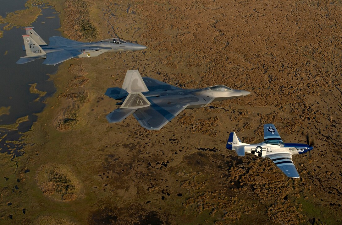 OVER VIRGINA (AFPN) - An F-15 Eagle, F/A-22 Raptor and P-51 Mustang train for heritage flight formation flying here April 27.  Maj. Michael Shower, piloting the F/A-22, is getting his checkout ride for the formation with P-51 Pilot Maj. Gen. Mike Decuir, the Air Combat Command operations director, and Capt. Jason Costello, a 1st Fighter Wing demonstration team pilot.  (U.S. Air Force photo by Tech. Sgt. Ben Bloker)