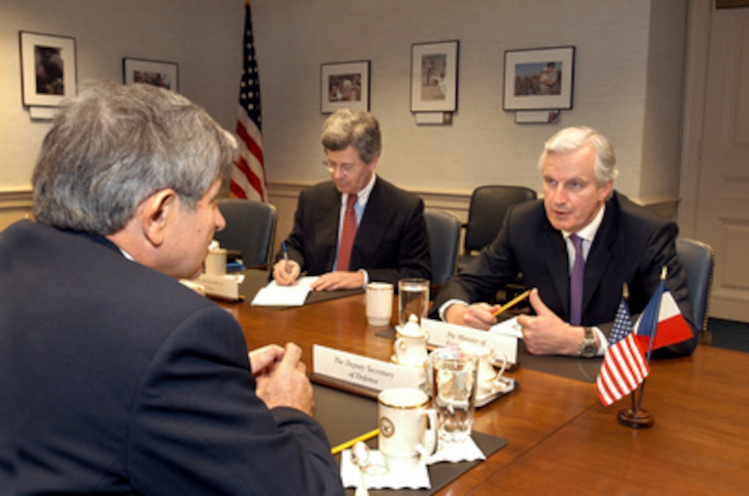 French Minister of Foreign Affairs Michel Barnier (right) meets with Deputy Secretary of Defense Paul Wolfowitz (foreground) in the Pentagon on May 2, 2005. Taking notes on the discussions is French Ambassador to the U.S. Jean-David Levitte (center). 