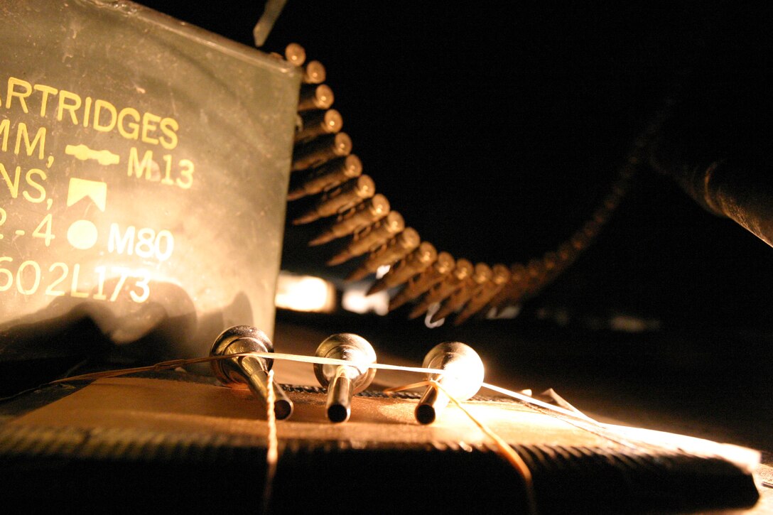 AL ASAD, Iraq--May 4, 2005, Mouthpieces from a French horn and an ammunition box  from a 240 Golf machine gun contrast the diverse mission of the 2nd Marine Aircraft Wing Band here.  While forward deployed the 2nd Marine Aircraft Wing Band provides security to the Tactical Air Command Center here. (USMC photo by Cpl. Alicia M. Garcia)