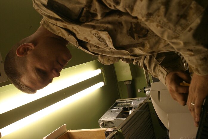 CAMP FALLUJAH, Iraq -- Lance Cpl. Travis Nichelson, a ground radio repair technician with Communications repair section, tries to repair an amplifier unit.  Nichelson, a North Platte, Neb., native, is assigned to Maintenance Company, Combat Logistics Battalion 8, 2d Force Service Support Group (Forward).