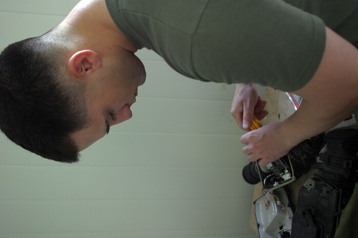 CAMP FALLUJAH, Iraq -- Lance Cpl. Nicholas DeLuca, a Long Island, N.Y., native and optics technician with Infantry Weapons repair section, works on a thermal imaging sight. Infantry Weapons repair section is part of Maintenance Company, Combat Logistics Battalion 8, 2d Force Service Support Group (Forward).