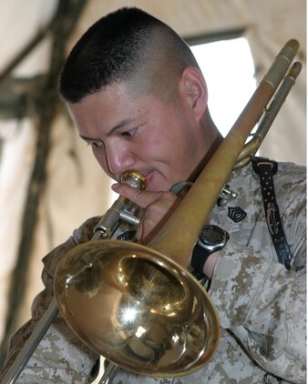 AL ASAD, Iraq--May 5, 2005. Gunnery Sgt. Michael R. Montoya a Virginia Beach, Va., native, the drum major for the 2nd Marine Aircraft Wing Band and the TACC security chief, practices a piece of music for an upcoming performance. Though the 2nd MAW bands primary mission while forward deployed is security, band members still also perform for special occasions.
