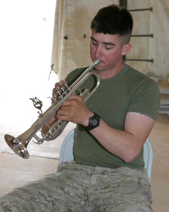May 3, 2005, Corporal Justin Lineman, a trumpet player in the 2D marine Aircraft Wing Band, practices a piece of music for an upcoming performance. Though the 2d MAW bands primary mission while forward deployed is security, band members still also perform for special occasions. (USMC photo by Cpl. Alicia M. Garcia)