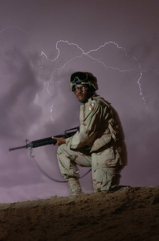 U.S. Army Pfc. Ray Brownlee stands a night watch at Forward Operating Base Hotel as a storm rapidly approaches Najaf, Iraq, on April 26, 2005. Brownlee is attached to 1st Battalion, 198th Armor, Headquarters Company, 155th Brigade Combat Team deployed in support of Operation Iraqi Freedom. 