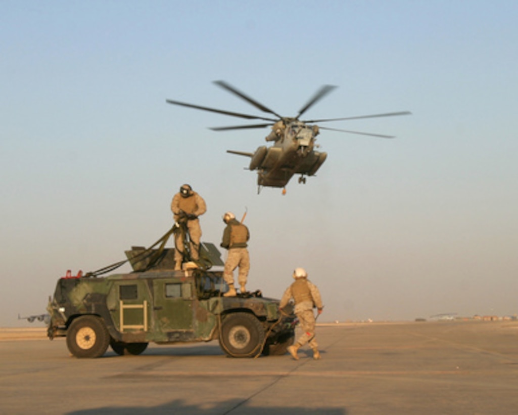 U.S. Marines from Combat Logistics Battalion 2 make final preparations to a Humvee so that it can be airlifted by the incoming CH-53E Super Stallion helicopter from the flight line of Al Asad, Iraq, to forward deployed Marines on the ground on May 3, 2005. Marines from 3rd battalion, 25th Marines will use the Humvee in support of Operation Iraqi Freedom. 