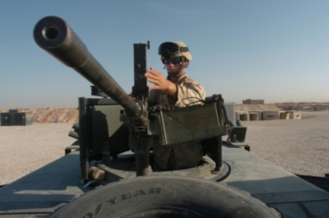 Army Sgt. Chris Branson prepares a M2 .50-caliber heavy machine gun on top of his Humvee prior to departing for a live fire weapons training exercise for the Iraqi National Guard at Forward Operating Base Duke in Najaf, Iraq, on April 13, 2005. The U.S. Army is currently assisting in establishing Iraq's defensive forces as part of the rebuilding process of Operation Iraqi Freedom. 