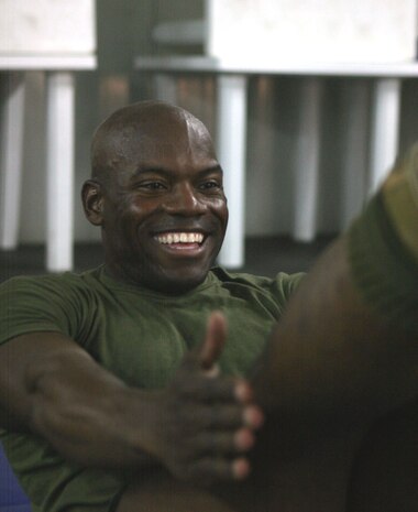 CAMP FALLUJAH, Iraq -- Lance Cpl. Robert Walker, an administrative clerk with Headquarters Company, Combat Logistics Battalion 8, 2d Force Service Support Group (Forward), works out at the "Killer Abs" class taught at the Morale, Welfare and Recreation center here.  The 32-year-old native of Peoria, Ill., was a cheerleader in college and said he wants to stay in the best possible shape.