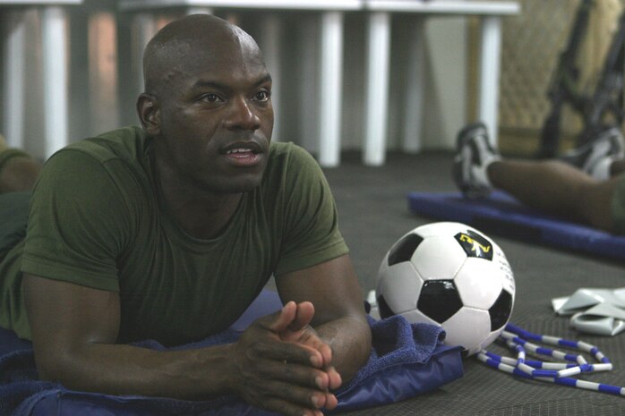 CAMP FALLUJAH, Iraq -- Lance Cpl. Robert Walker, an administrative clerk with Headquarters Company, Combat Logistics Battalion 8, 2d Force Service Support Group (Forward), watches intently as the instructor for the "Killer Abs" class demonstrates the next exercise.  Walker, a 32-year-old native of Peoria, Ill., said he likes to work out citing "I just don't like to be fat," for his main reason.