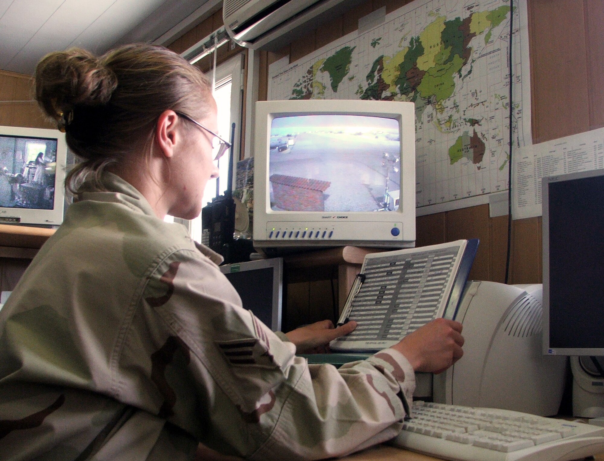 KARSHI-KHANABAD AIR BASE, Uzbekistan -- Senior Airman MaRyha Self looks over a log sheet here May 4.  She is a controller for the 416th Air Expeditionary Group's command post and is deployed from Barksdale Air Force Base, La.  (U.S. Air Force photo by Tech. Sgt. Scott T. Sturkol)