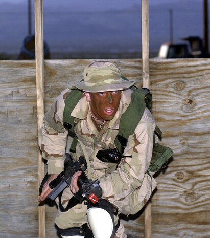 NELLIS AIR FORCE BASE, Nev. -- First Lt. Eric Stride runs for cover during a training exercise here.  He was on the opposing force trying to break into the training camp.  The three-day exercise included training on first aid, convoys and map reading to help prepare 99th Civil Engineer Squadron Airmen for deployment.  Lieutenant Stride is the 99th Communications Squadron's network control center crew commander.  (U.S. Air Force photo by Tech. Sgt. Demetrius Lester)