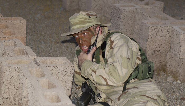 NELLIS AIR FORCE BASE, Nev. -- First Lt. Eric Stride calls for backup while participating in a training exercise here.  He was on the opposing force trying to break into the training camp.  The three-day exercise included training on first aid, convoys and map reading to help prepare 99th Civil Engineer Squadron Airmen for deployment.  Lieutenant Stride is the 99th Communications Squadron's network control center crew commander.  (U.S. Air Force photo by Tech. Sgt. Demetrius Lester)