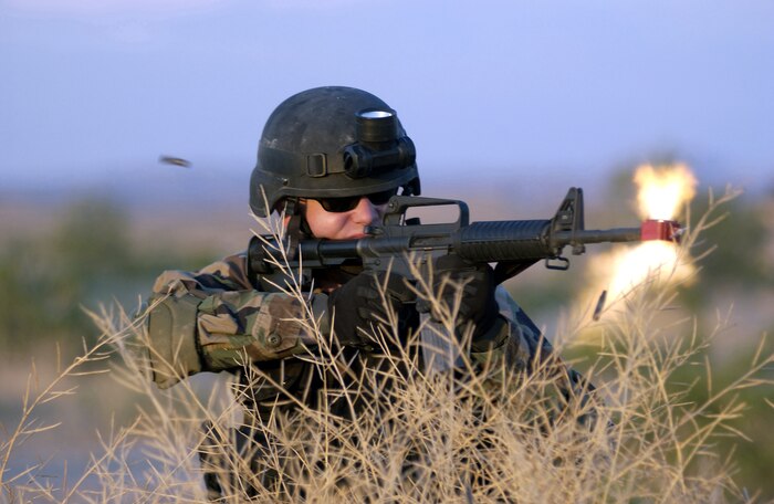 NELLIS AIR FORCE BASE, Nev. -- Senior Airman Dan Solon fires at opposing forces during a training exercise here.  The three-day exercise included training on first aid, convoys and map reading to help prepare Airmen for deployment.  Airman Solon is assigned to the 99th Civil Engineer Squadron's explosive ordnance disposal flight.  (U.S. Air Force photo by Tech. Sgt. Demetrius Lester)
