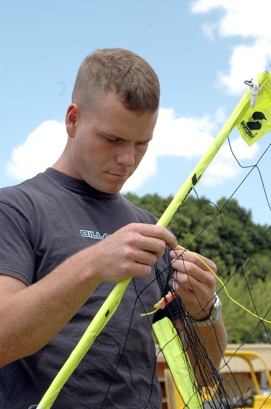 Sgt. Daniel Holub, a Marrion, Kan., native and ordnance technician with VMA-214, sets up a volleyball net for the unit's family picnic. The event was the first time VMA-214 had the opportunity to relax as a full unit after returning from deployments and working as the sole Harrier support for Weapons and Tactics Instructor course 2-05.